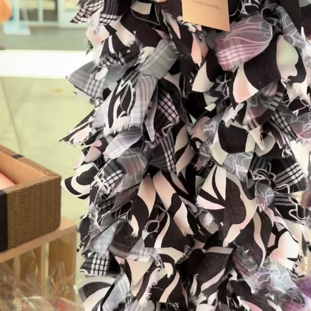 Handmade fabric ribbon leis displayed at a Coconut Moon pop-up craft fair.